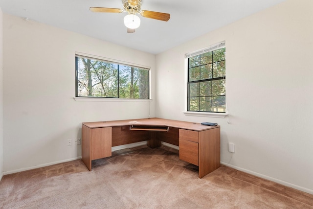 office area featuring light carpet and ceiling fan