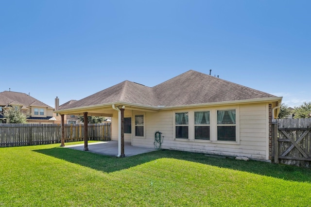 back of property with a yard and a patio