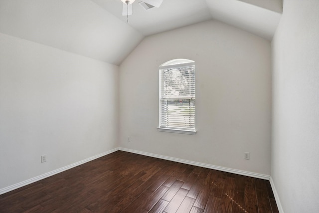 spare room featuring ceiling fan, dark hardwood / wood-style flooring, and vaulted ceiling