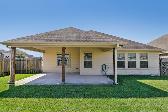 back of house featuring a patio area and a yard