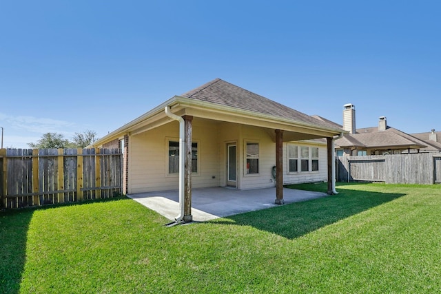 rear view of house featuring a patio and a lawn