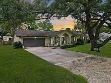 view of front facade with a lawn and a garage