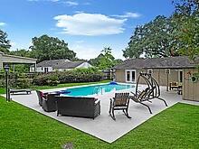 view of swimming pool featuring a yard and a patio