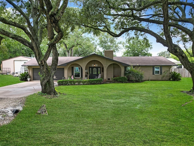 ranch-style house featuring a garage and a front lawn