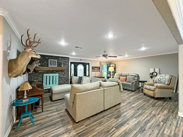 living room featuring a fireplace, dark hardwood / wood-style flooring, and ornamental molding