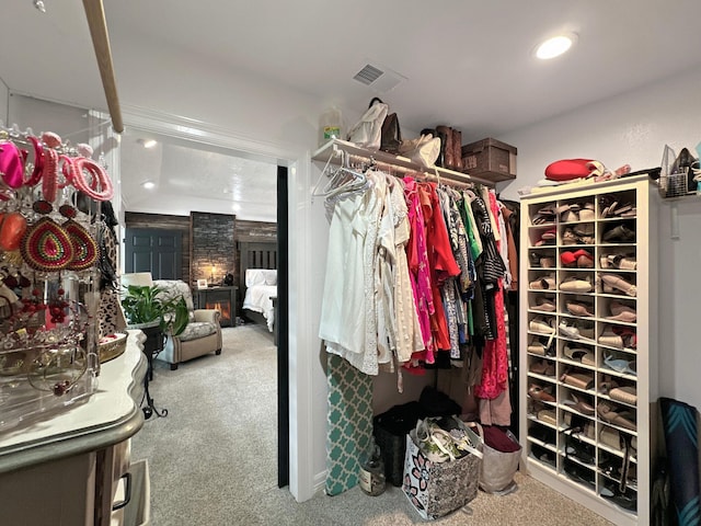 walk in closet featuring carpet flooring