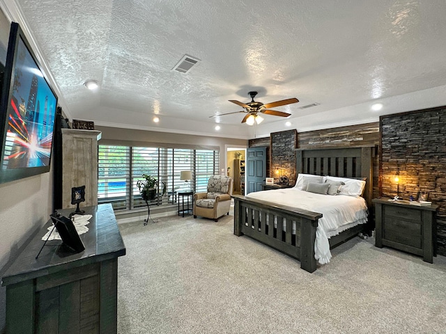 carpeted bedroom featuring ceiling fan, ornamental molding, and a textured ceiling