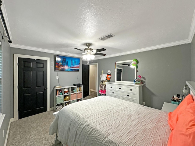 bedroom with carpet, ceiling fan, ornamental molding, and a textured ceiling