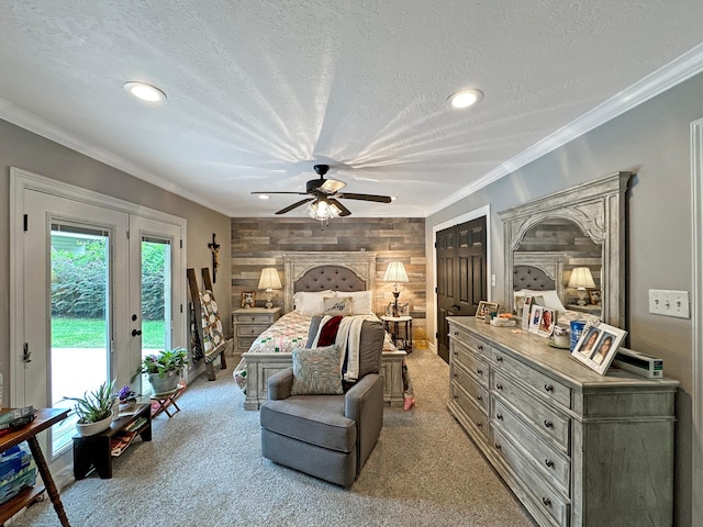 bedroom with a textured ceiling, access to outside, ceiling fan, and wood walls