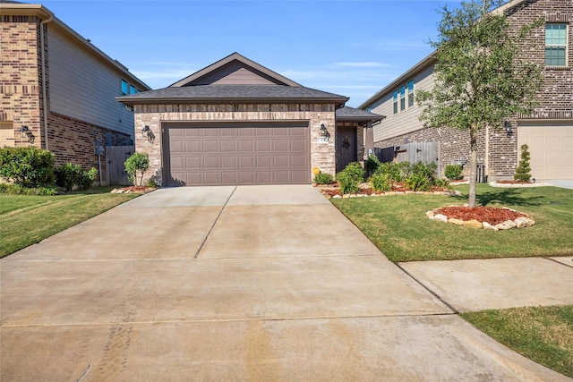 view of front of property featuring a front yard and a garage