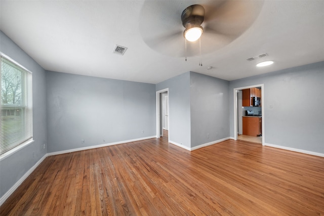 empty room featuring ceiling fan and light hardwood / wood-style floors