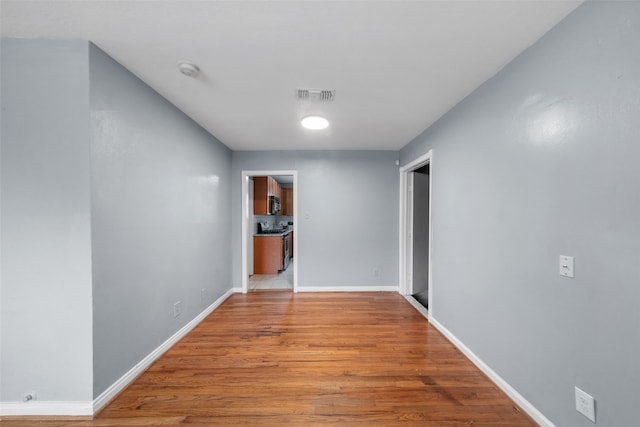 corridor featuring light hardwood / wood-style floors