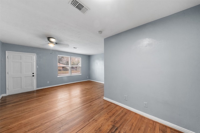 spare room with ceiling fan and hardwood / wood-style flooring