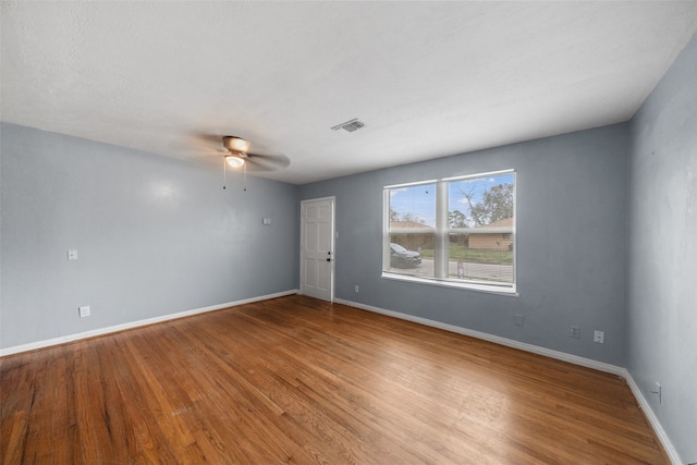 empty room featuring ceiling fan and hardwood / wood-style floors