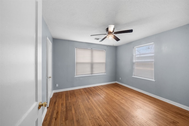 unfurnished room featuring a textured ceiling, ceiling fan, and hardwood / wood-style flooring