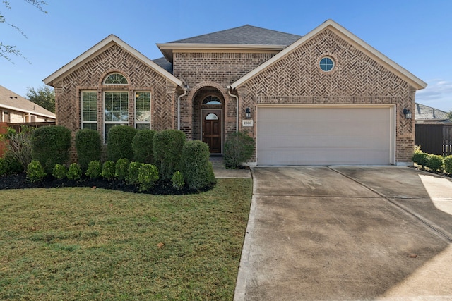 view of front of house with a garage and a front lawn