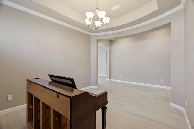 2206 Wolf Creek Ct, Katy, TX 77493 - office area featuring a chandelier, crown molding, light wood-style floors, arched walkways, and a raised ceiling
