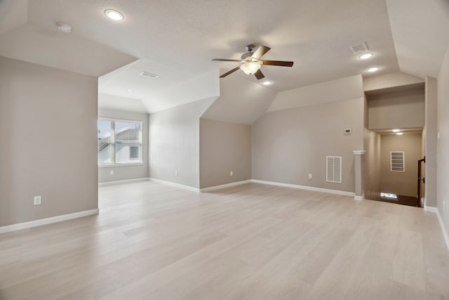 bonus room with a textured ceiling, light wood-type flooring, vaulted ceiling, and ceiling fan