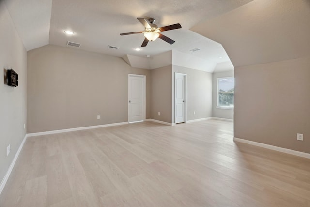 interior space with a textured ceiling, ceiling fan, vaulted ceiling, and light wood-type flooring