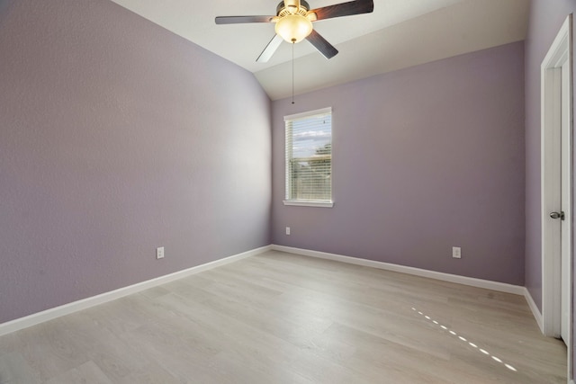 spare room featuring light wood-type flooring, ceiling fan, and lofted ceiling