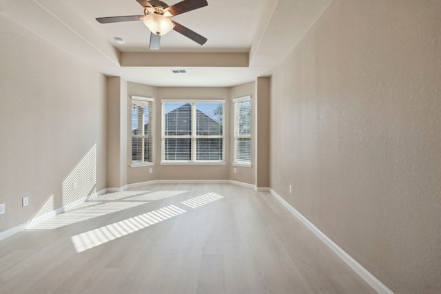 empty room with ceiling fan and light wood-type flooring