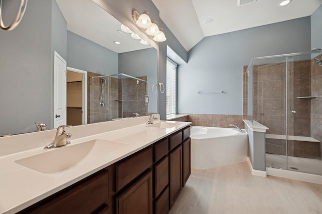 bathroom with vanity, hardwood / wood-style floors, plus walk in shower, and lofted ceiling