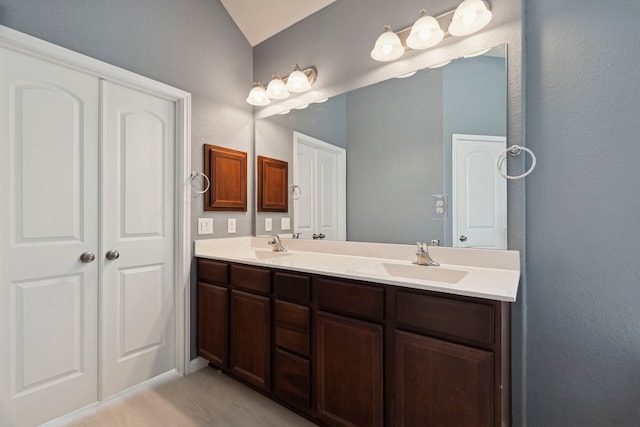 2206 Wolf Creek Ct, Katy, TX 77493 - full bath featuring vaulted ceiling, double vanity, and a textured wall