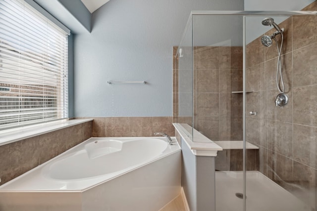 2206 Wolf Creek Ct, Katy, TX 77493 - bathroom with a shower stall, a bath, and a textured wall