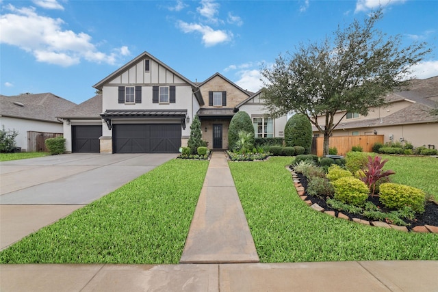 tudor home featuring a front yard and a garage