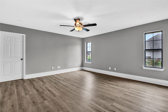 unfurnished room with ceiling fan and light wood-type flooring