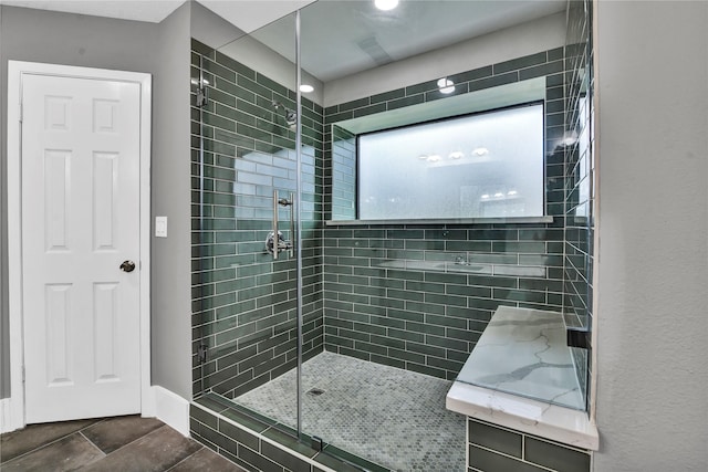 bathroom featuring tile patterned floors and tiled shower