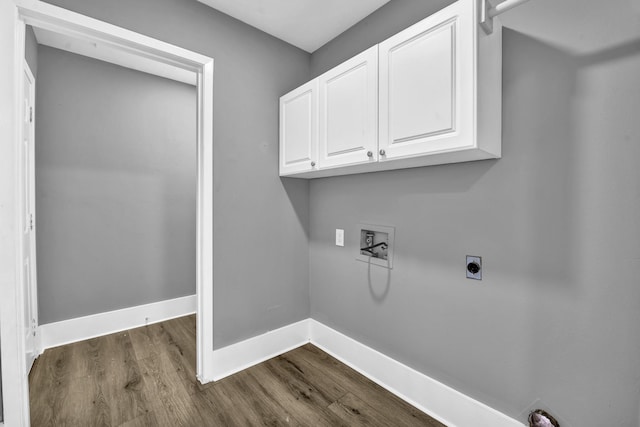 clothes washing area featuring hardwood / wood-style floors, hookup for a washing machine, cabinets, and hookup for an electric dryer