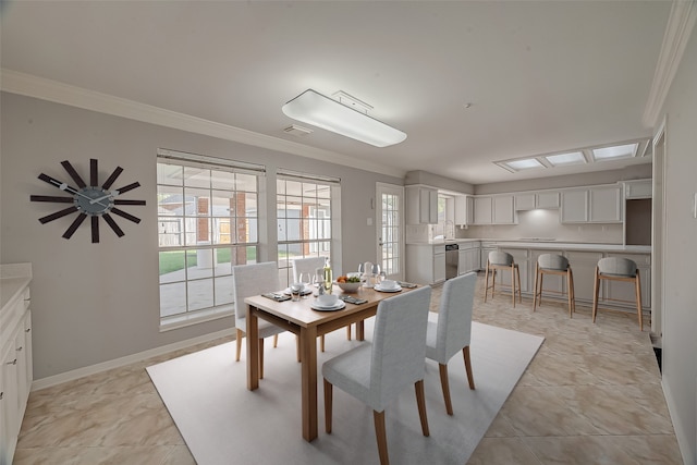 dining space featuring crown molding, plenty of natural light, and sink