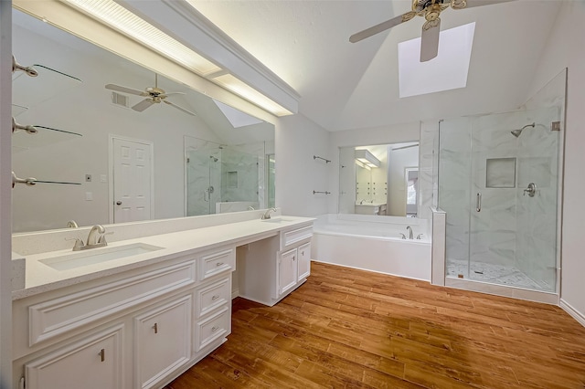 bathroom with plus walk in shower, wood-type flooring, vanity, and vaulted ceiling