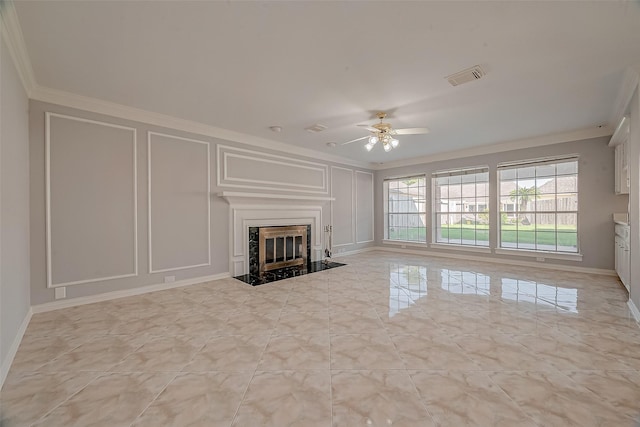 unfurnished living room featuring ceiling fan, ornamental molding, and a premium fireplace