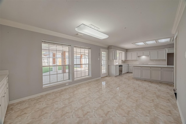 kitchen with dishwasher, sink, and crown molding