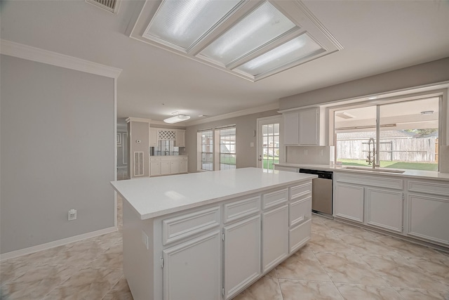 kitchen featuring white cabinetry, sink, a kitchen island, and stainless steel dishwasher