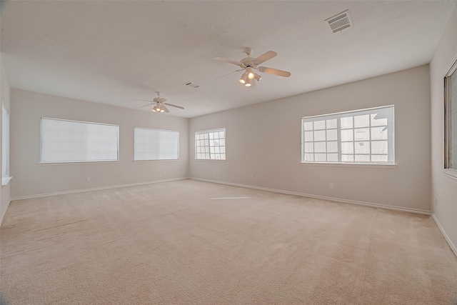 unfurnished room featuring ceiling fan and light carpet