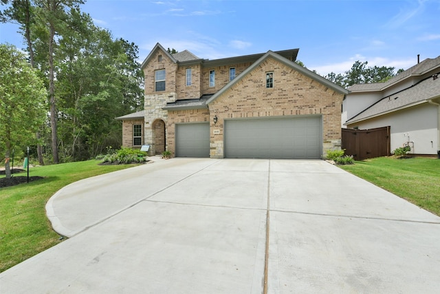 16146 Rustling Woods Rd, Conroe, TX 77302 - view of front of house with brick siding, an attached garage, and concrete driveway