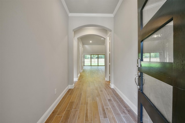 16146 Rustling Woods Rd, Conroe, TX 77302 - hall with light wood-style floors, plenty of natural light, arched walkways, and crown molding