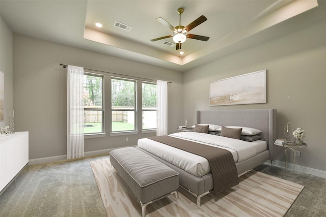 16146 Rustling Woods Rd, Conroe, TX 77302 - carpeted bedroom with a tray ceiling, a ceiling fan, and recessed lighting