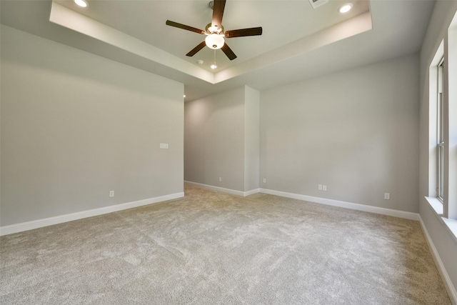 16146 Rustling Woods Rd, Conroe, TX 77302 - empty room featuring recessed lighting, ceiling fan, a tray ceiling, and light carpet