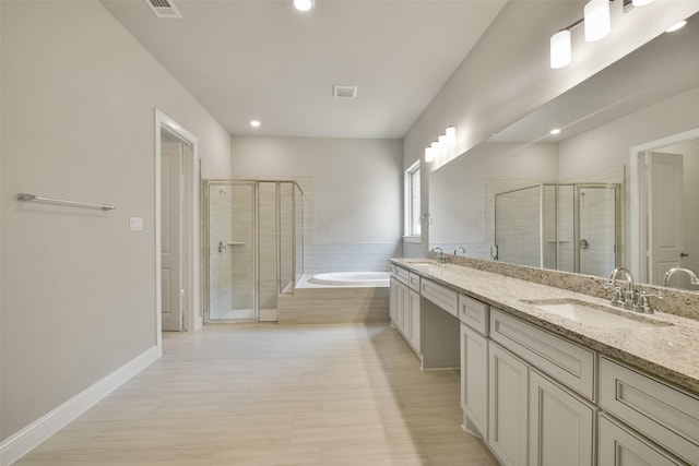 16146 Rustling Woods Rd, Conroe, TX 77302 - bathroom featuring double vanity, a stall shower, a bath, and recessed lighting
