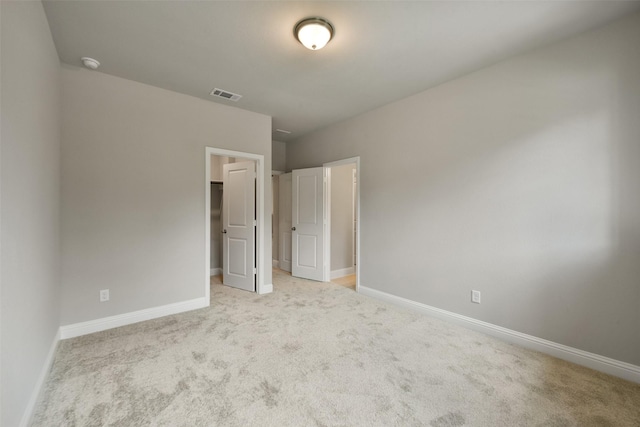 16146 Rustling Woods Rd, Conroe, TX 77302 - unfurnished bedroom featuring light carpet and a walk in closet