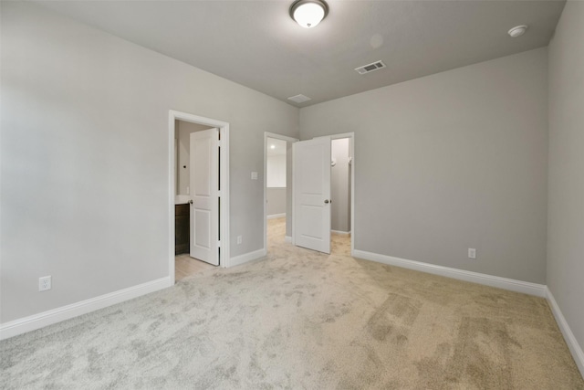 16146 Rustling Woods Rd, Conroe, TX 77302 - unfurnished bedroom featuring light colored carpet and ensuite bath