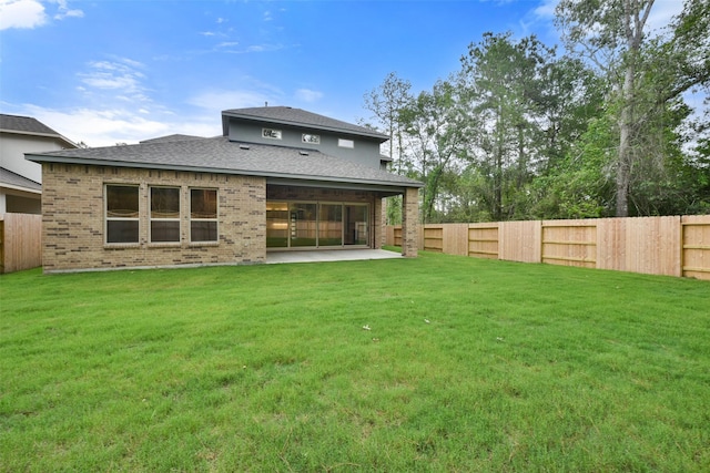 16146 Rustling Woods Rd, Conroe, TX 77302 - back of house featuring a fenced backyard, a patio, a shingled roof, and brick siding