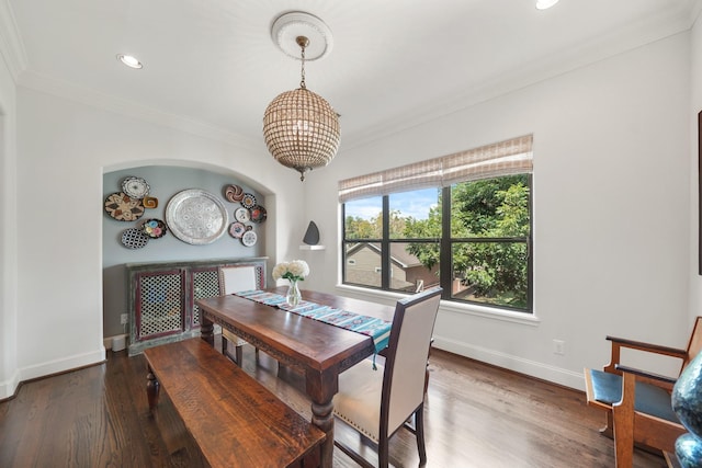 dining room featuring crown molding and dark wood-type flooring