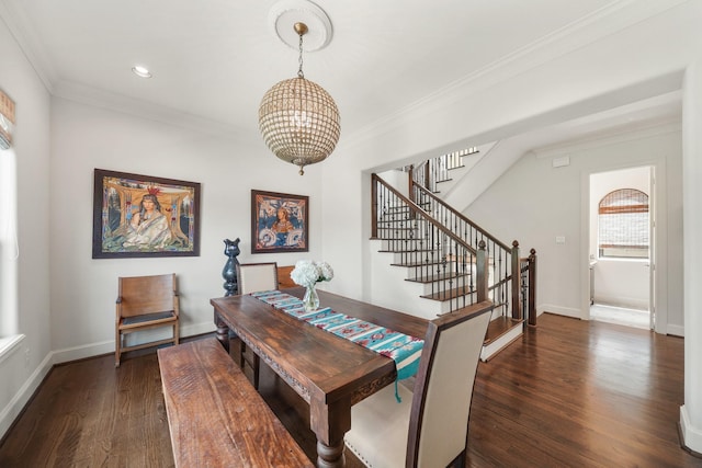 dining room with crown molding, dark wood-type flooring, and a chandelier