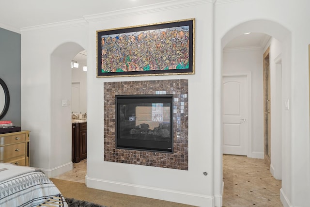 bedroom with a multi sided fireplace and crown molding