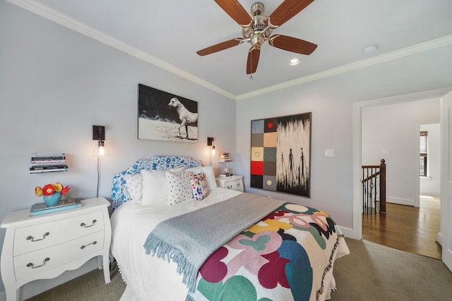 bedroom with dark colored carpet, ceiling fan, and ornamental molding